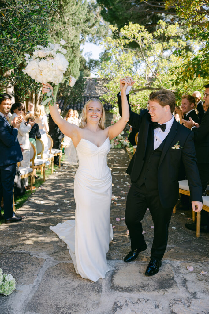  just-married-couple-exit-chateau-de-cassis-destination-wedding-planner-provence-france-scaled.